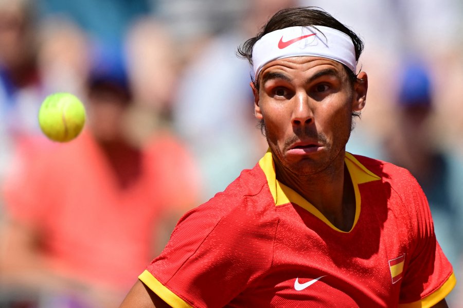 Spain's Rafael Nadal eyes the ball as he returns to Serbia's Novak Djokovic during their men's singles second round tennis match on Court Philippe-Chatrier at the Roland-Garros Stadium at the Paris 2024 Olympic Games.