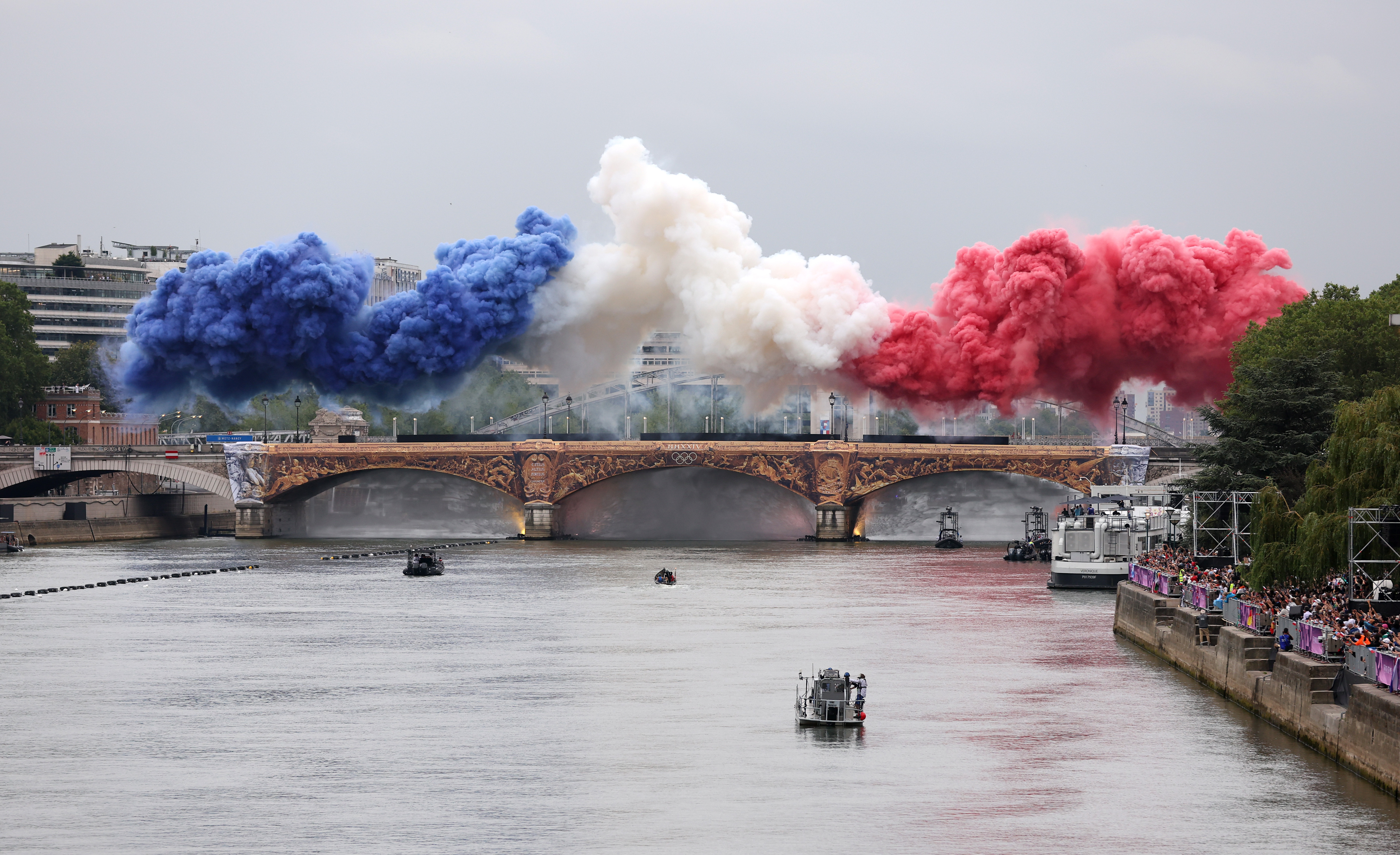 Smoke resembling the flag of Team France is shown over Austerlitz Bridge during the opening ceremony of the Olympic Games Paris 2024 on July 26, 2024 in Paris, France.