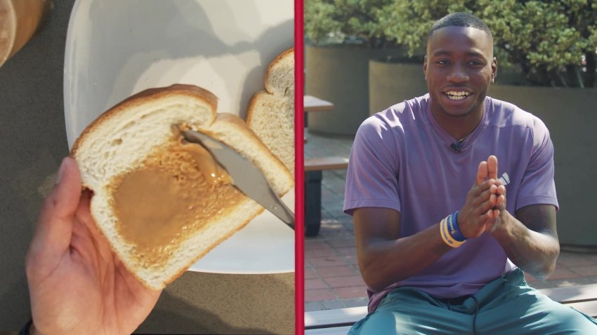 A slice of bread with peanut butter next to Grant Holloway sitting down