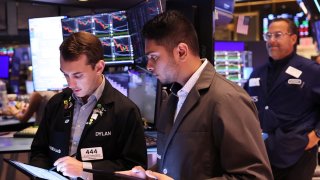 Traders work on the floor of the New York Stock Exchange during morning trading on August 06, 2024 in New York City. 