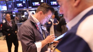 Traders work on the floor of the New York Stock Exchange during morning trading on August 12, 2024 in New York City. 