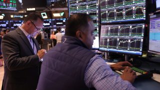 Traders work on the floor of the New York Stock Exchange during morning trading on August 20, 2024 in New York City. 