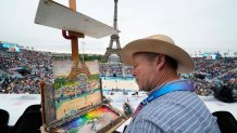 Peter Spens, of London, England, paints the scene at Eiffel Tower