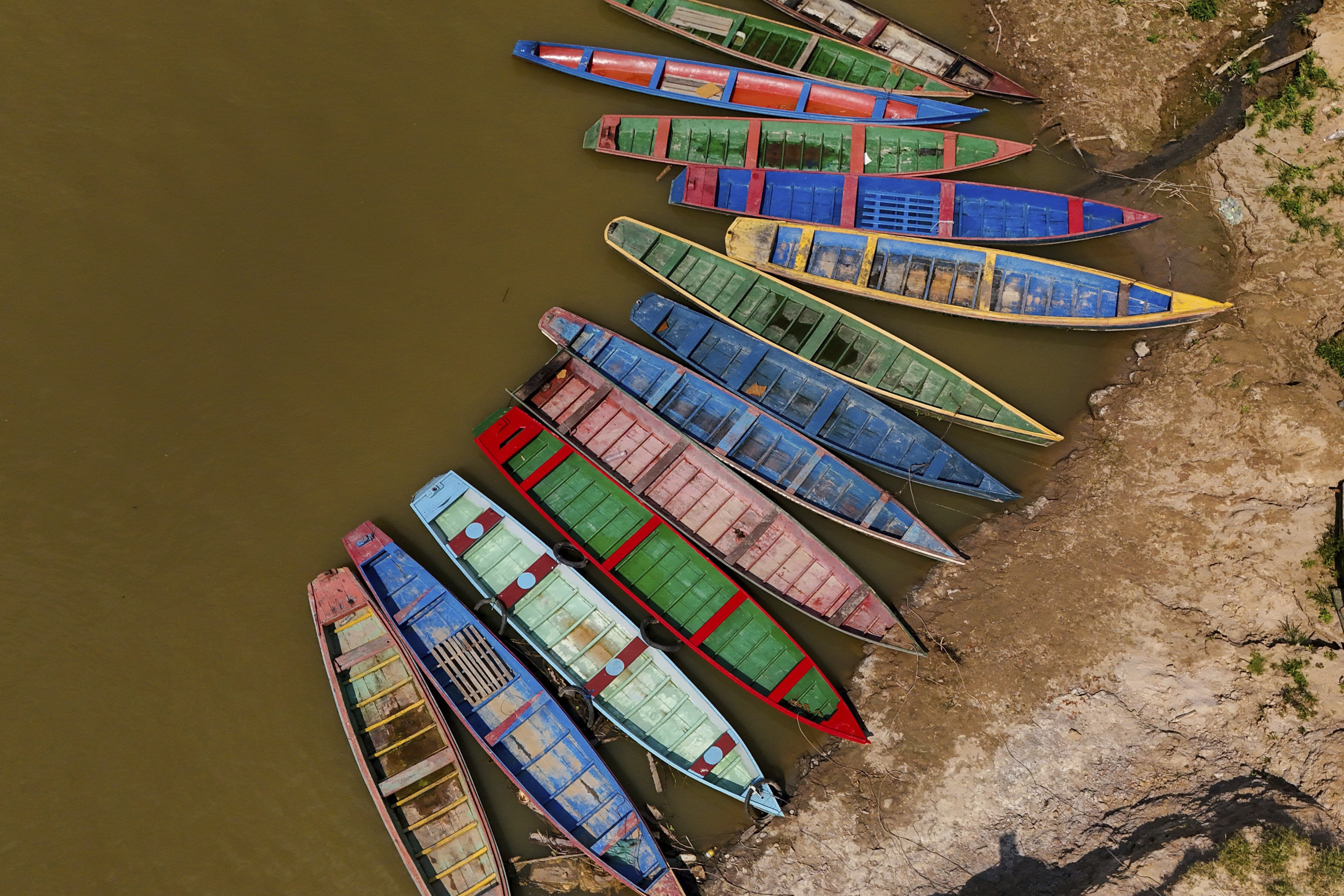 Boats sit on the bank of the Acre River, the main water source for the city of Rio Branco, which is facing water shortages amid a drought in Acre state, Brazil, Friday, Aug. 2, 2024. (AP Photo/Marcos Vicentti)