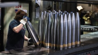 An employee handles 155 mm caliber shells after the manufacturing process at the Scranton Army Ammunition Plant (SCAAP) in Scranton, Pennsylvania on April 16, 2024.