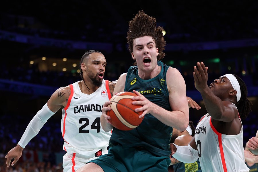 Josh Giddey of Team Australia grabs the rebound from Luguentz Dort of Team Canada