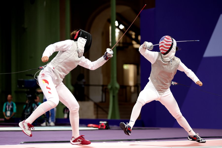 Lee Kiefer of Team United States and Yuting Wang of Team People's Republic of China compete during the Womens Foil Team Table of 8 match between Team People’s Republic of China and Team United States on day six of the Olympic Games Paris 2024 at Grand Palais on August 01, 2024 in Paris, France