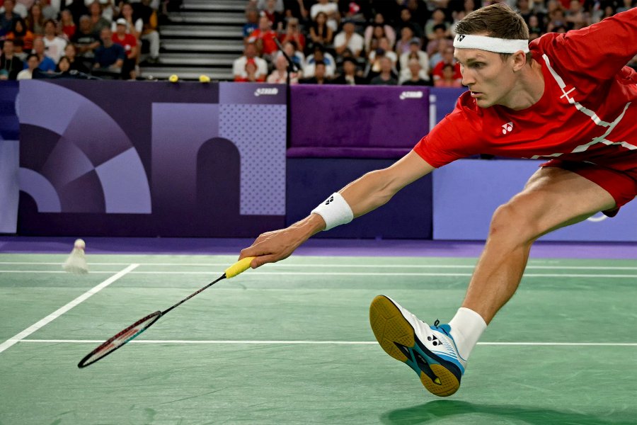 Denmark's Viktor Axelsen plays a shot against Thailand's Kunlavut Vitidsarn in the men's singles badminton final match during the Paris 2024 Olympic Games at Porte de la Chapelle Arena in Paris on August 5, 2024