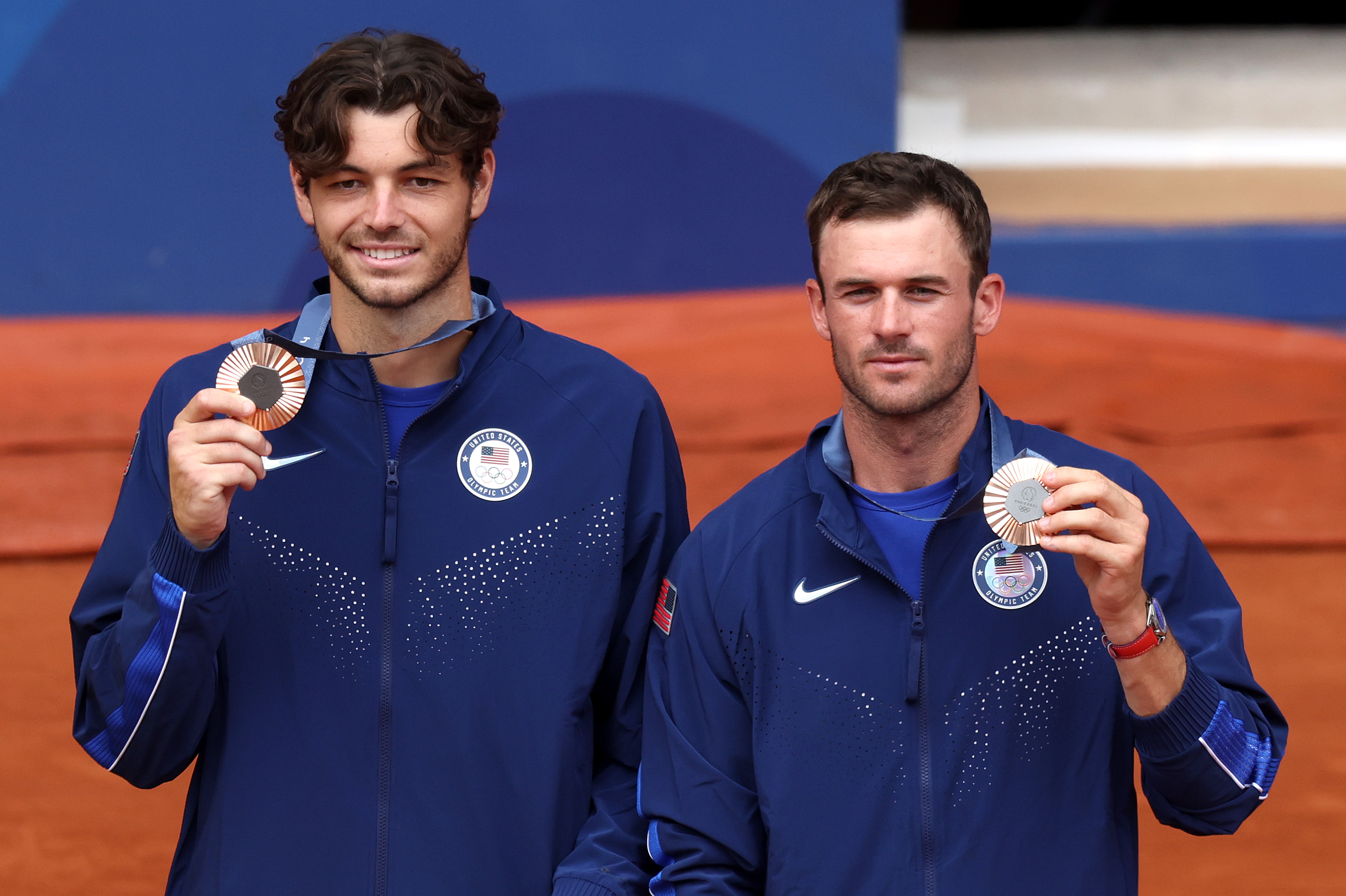 PARIS, FRANCE - AUGUST 03: Bronze medallists Taylor Fritz and Tommy Paul of Team United States (R) pose on the podium during the Tennis Men's Doubles medal ceremony after the Tennis Men's Doubles matches on day eight of the Olympic Games Paris 2024 at Roland Garros on August 03, 2024 in Paris, France. (Photo by Clive Brunskill/Getty Images)