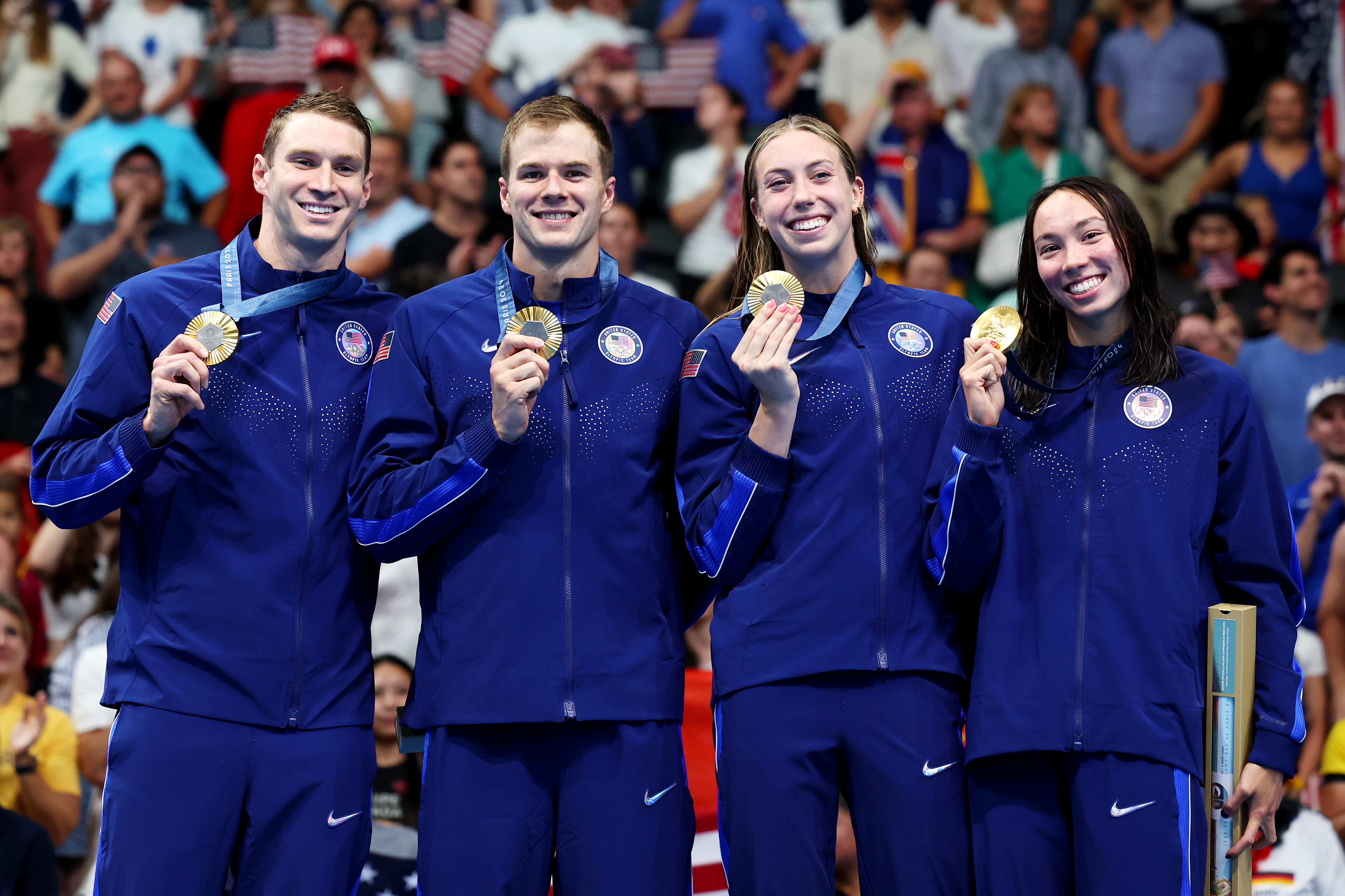 NANTERRE, FRANCE - AUGUST 03: Gold Medalists Ryan Murphy, Nic Fink, Gretchen Walsh and Torri Huske of Team United States pose on the podium during the Swimming medal ceremony after the Mixed 4x100m Medley Relay Final on day eight of the Olympic Games Paris 2024 at Paris La Defense Arena on August 03, 2024 in Nanterre, France. (Photo by Quinn Rooney/Getty Images)