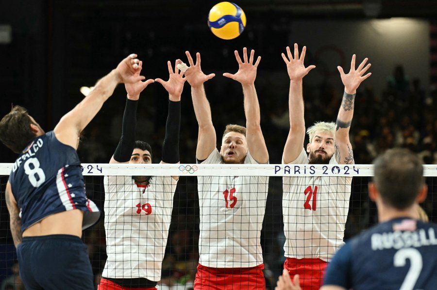 Polish players block the ball