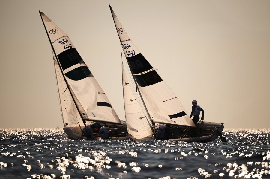 Noa Lasry and Nitai Hasson of Team Israel and Henrique Duarte Haddad and Isabel Swan of Team Brazil compete in the Mixed Dinghy 470 class on day ten of the Olympic Games Paris 2024 at Marseille Marina on August 05, 2024 in Marseille, France