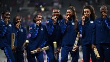 Gold medallists (from L) US' Quanera Hayes, Aaliyah Butler, Kaylyn Brown, Alexis Holmes, Gabriel Thomas, Sydney McLaughlin-Levrone and Shamier Little celebrate on the podium after competing in the women's 4X400m relay final of the athletics event during the Paris 2024 Olympic Games at Stade de France in Saint-Denis, north of Paris, on August 10, 2024. (Photo by MARTIN BERNETTI / AFP) (Photo by MARTIN BERNETTI/AFP via Getty Images)