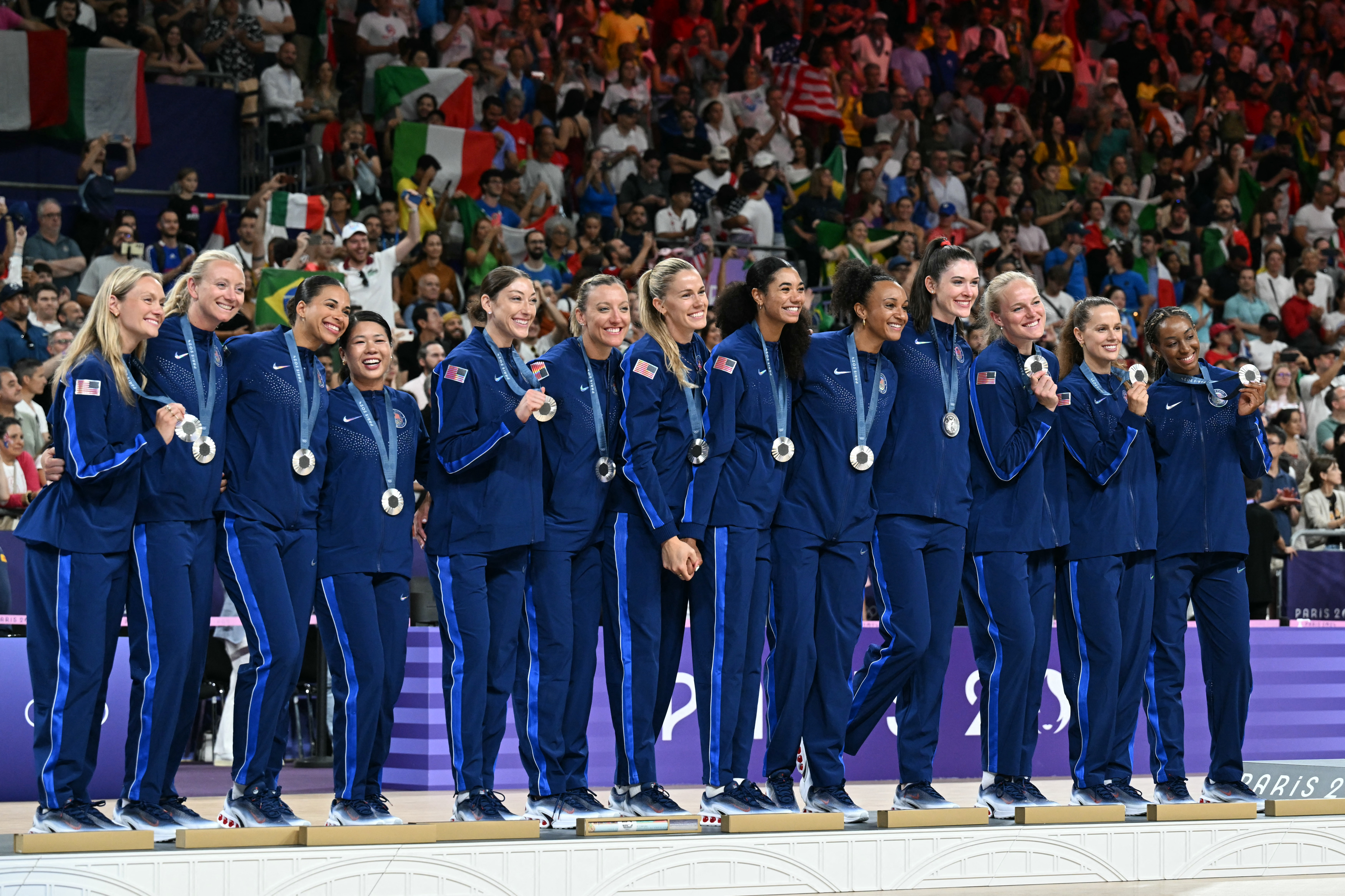 Silver medallists US' players pose on the podium during the award ceremony for the women's volleyball follwing the gold medal match between USA and Italy at the South Paris Arena 1 in Paris during the Paris 2024 Olympic Games on August 11, 2024. (Photo by Patricia DE MELO MOREIRA / AFP) (Photo by PATRICIA DE MELO MOREIRA/AFP via Getty Images)