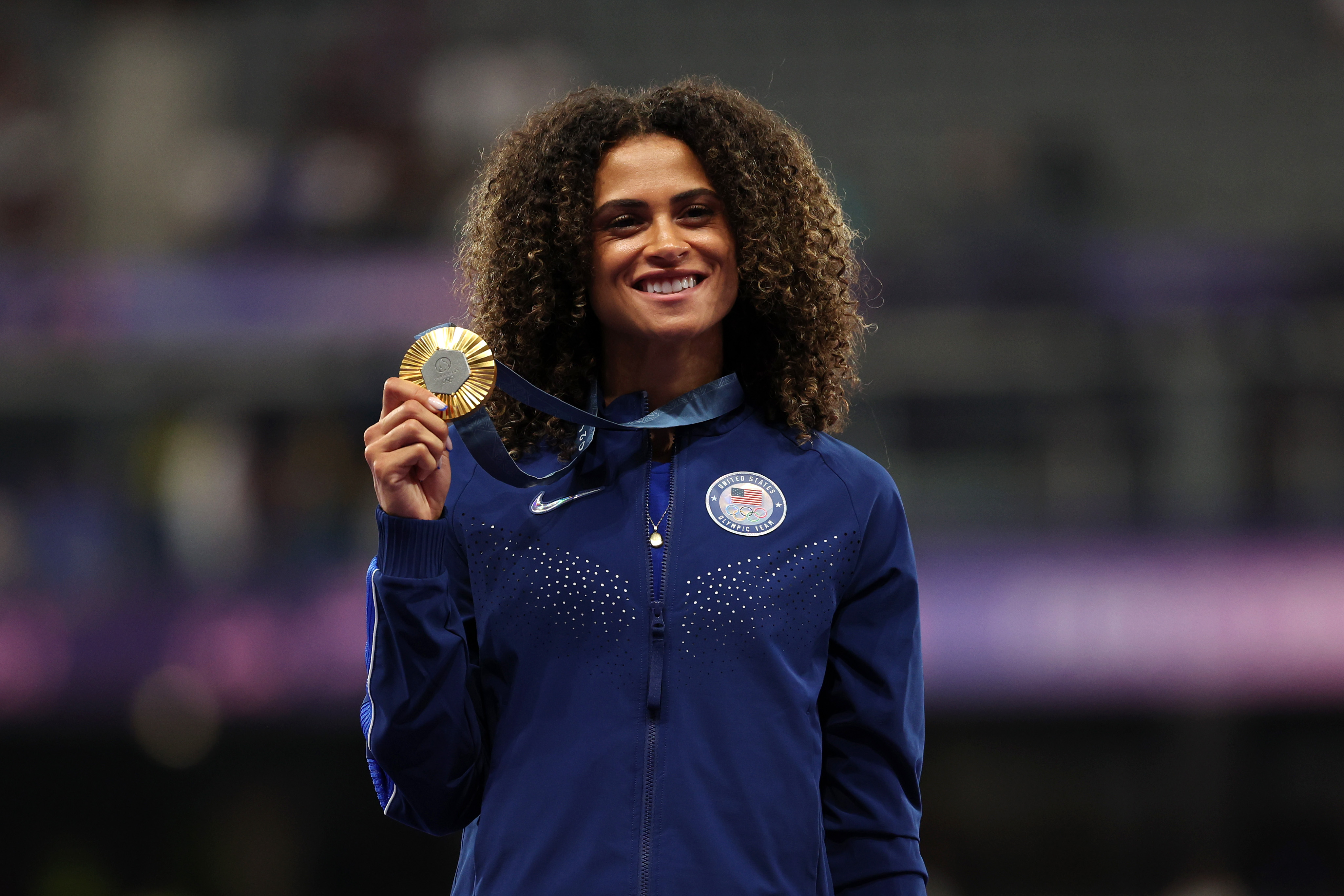 Gold medalist Sydney McLaughlin-Levrone of Team United States celebrates on the podium during the Women's 400m Hurdles medal ceremony on day fourteen of the Olympic Games Paris 2024 at Stade de France on August 09, 2024 in Paris, France. (Photo by Patrick Smith/Getty Images)