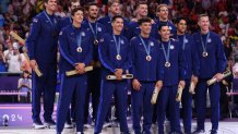 PARIS, FRANCE - AUGUST 10: Bronze medalists of Team United States celebrate on the podium during the Volleyball medal ceremony after the Men's Gold Medal Match on Day fifteen of the Olympic Games Paris 2024 at Paris Arena on August 10, 2024 in Paris, France. (Photo by Sarah Stier/Getty Images)