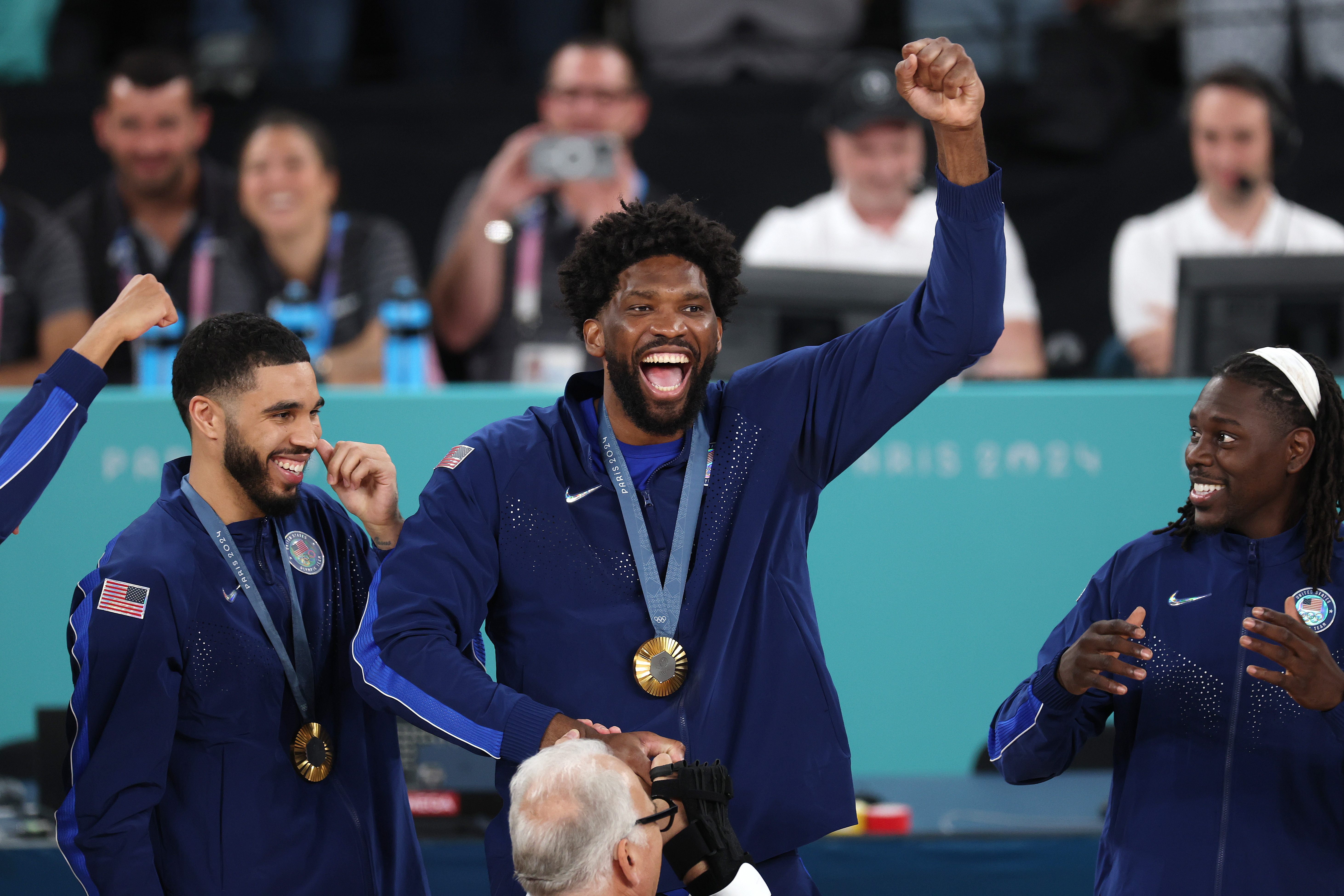 Joel Embiid holds up gold medal