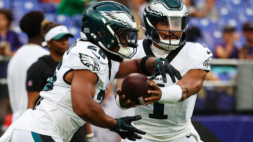 BALTIMORE, MD – AUGUST 09: Jalen Hurts #1 of the Philadelphia Eagles hands the ball off to Saquon Barkley #26 before a preseason game against the Baltimore Ravens at M&T Bank Stadium on August 9, 2024 in Baltimore, Maryland. (Photo by Scott Taetsch/Getty Images)