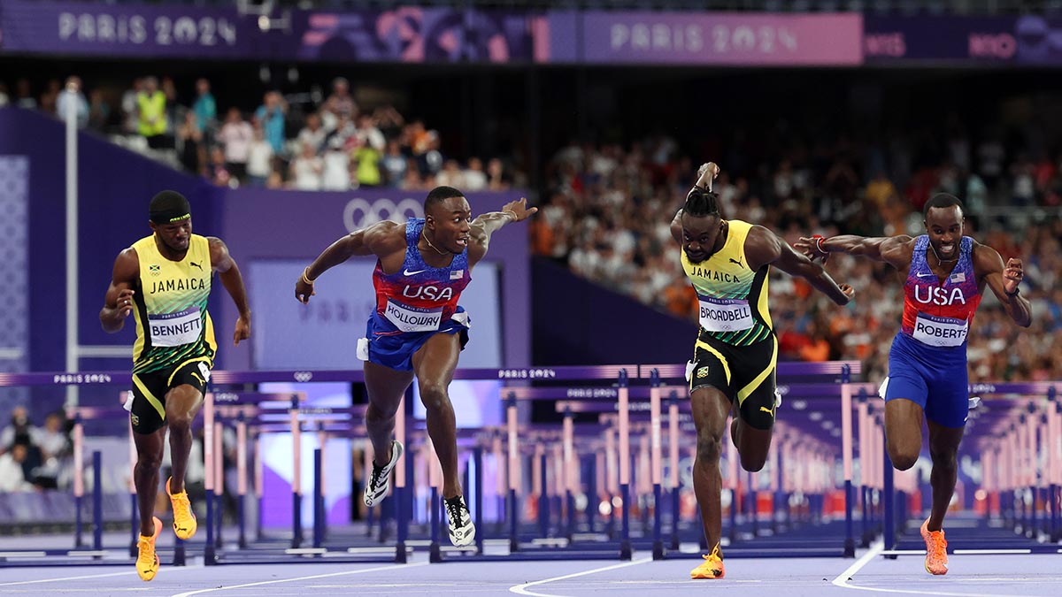 PARIS, FRANCE - AUGUST 08: Grant Holloway of Team United States (2nd L) wins the gold medal ahead of bronze medalist Rasheed Broadbell (C) of Team Jamaica and silver medal Daniel Roberts of Team United States cross the finish line in Men's 110m Hurdles  on day thirteen of the Olympic Games Paris 2024 at Stade de France on August 08, 2024 in Paris, France. (Photo by Hannah Peters/Getty Images)