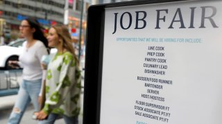 Signage for a job fair is seen on 5th Avenue after the release of the jobs report in Manhattan, New York City, September 3, 2021.