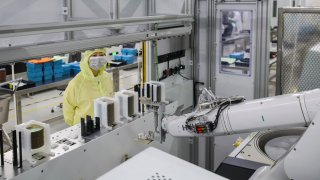 Workers are processing chips at a workshop of an optoelectronic technology company in Huai’an, China, on May 11, 2024. 