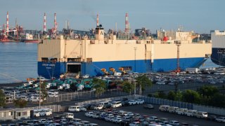 Vehicles bound for shipment parked in front of the Dream Angel vehicles carrier ship at the Nagoya Port in Nagoya, Japan, on Tuesday, June 18, 2024.