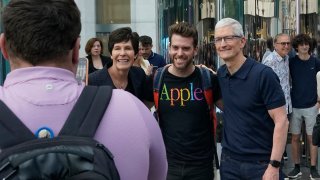 Apple CEO Tim Cook (R) poses for selfies with customers during Apple’s iPhone 16 launch in New York on September 20, 2024.