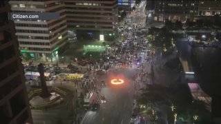 A fire burns in the middle of the street in front of Philadelphia's City Hall during a car meetup overnight on Saturday, Sept. 21, 2024.