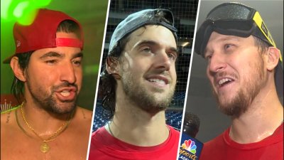 Phillies players react in the locker room to winning the NL East