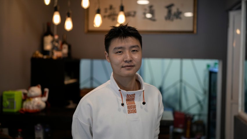 Owner Duan Fan poses in his Chinese restaurant “Nueve y media,”