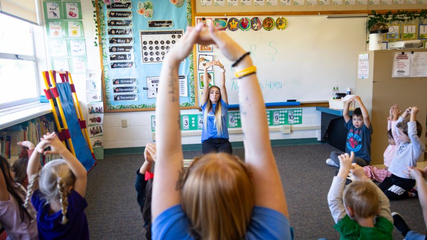 A teacher leads preschoolers in learning activities