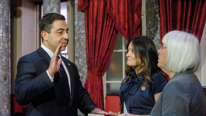 Sen. Patty Murray, D-Wash., right, administers the oath of office to Sen. George Helmy, D-N.J., left, as his wife Caroline Helmy holds the Bible during a re-enactment swearing-in.