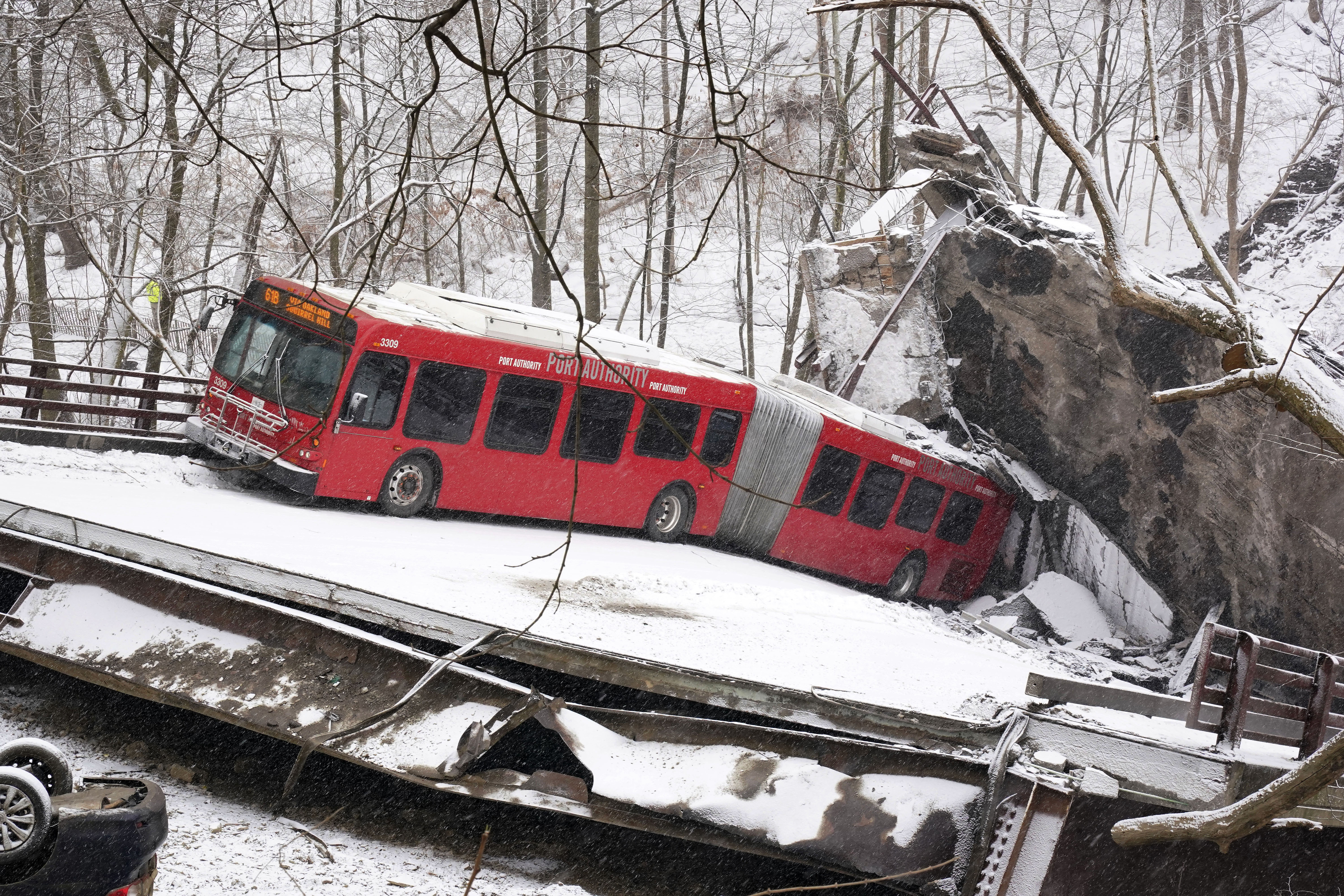 FILE—A Pittsburgh Transit Authority bus sits on the Fern Hollow Bridge in Pittsburgh after it collapsed in this on Jan. 28, 2022.   (AP Photo/Gene J. Puskar, File)