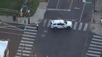 Police officer, SUV on taped off Philadelphia street.