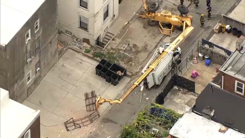 Construction lift collapsed onto work vehicle.