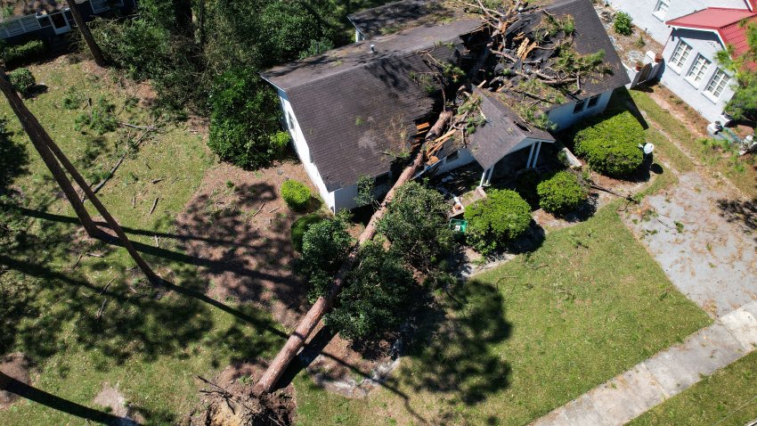 An aerial picture of a tree fallen on a house