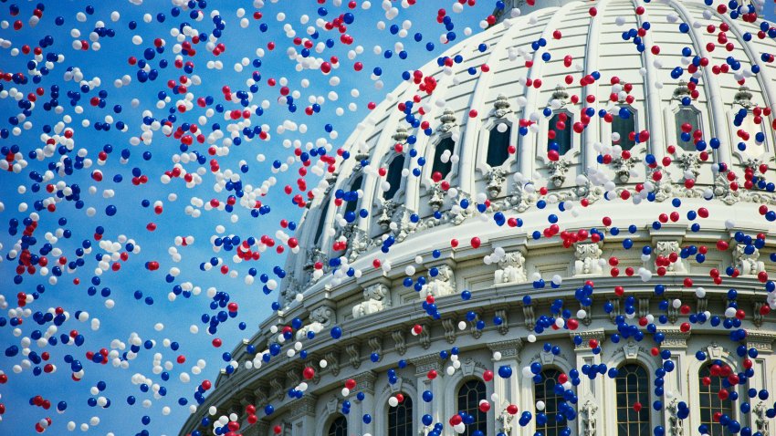 U.S. Capitol with red, white and blue balloons.