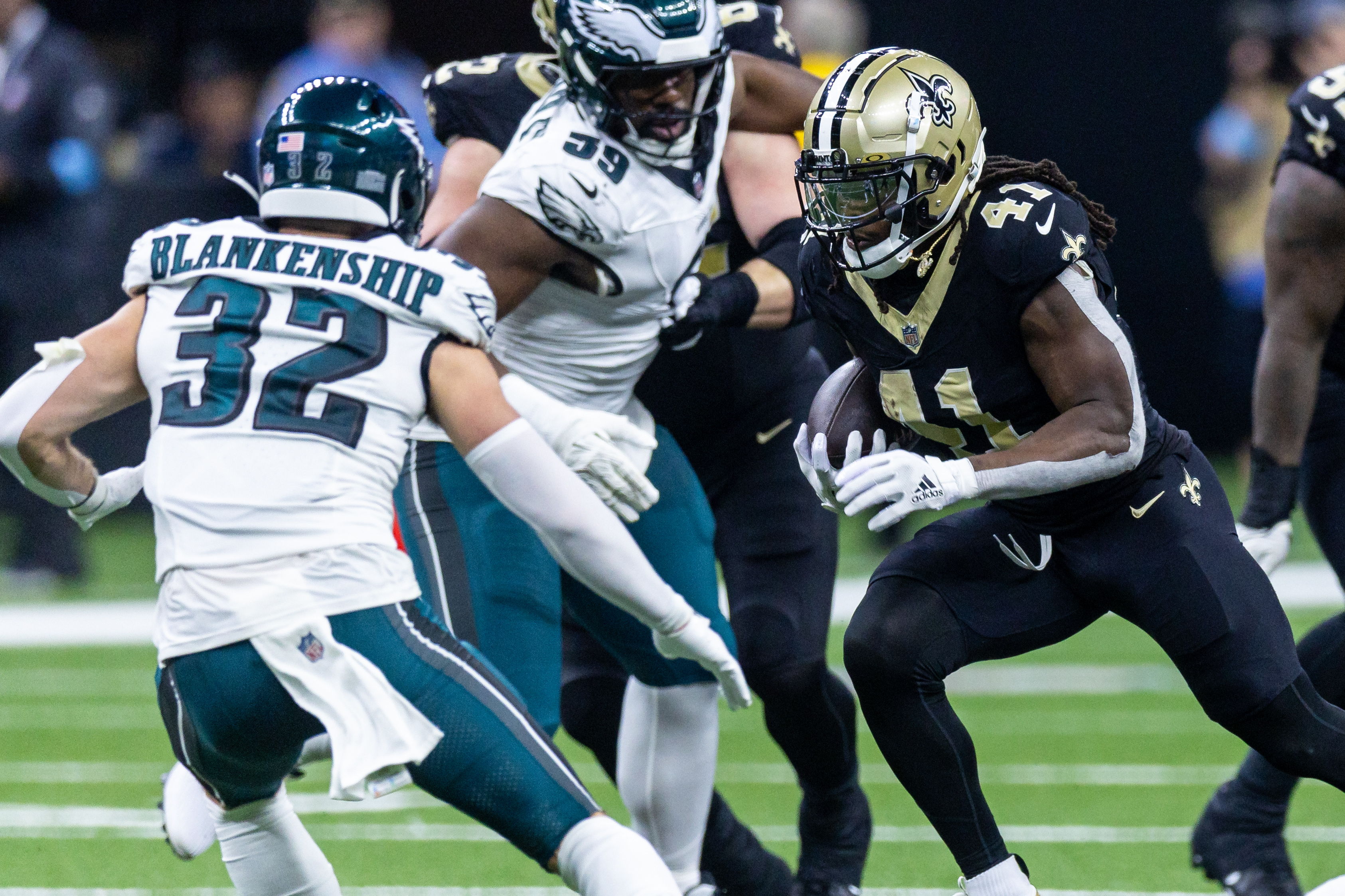 Sep 22, 2024; New Orleans, Louisiana, USA; New Orleans Saints running back Alvin Kamara (41) runs against Philadelphia Eagles safety Reed Blankenship (32) during the first half at Caesars Superdome. Mandatory Credit: Stephen Lew-Imagn Images
