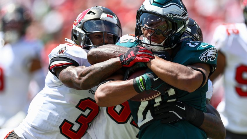 Sep 29, 2024; Tampa, Florida, USA; Philadelphia Eagles running back Saquon Barkley (26) is stopped by Tampa Bay Buccaneers safety Jordan Whitehead (3) and linebacker Lavonte David (54) in the first quarter at Raymond James Stadium. Mandatory Credit: Nathan Ray Seebeck-Imagn Images