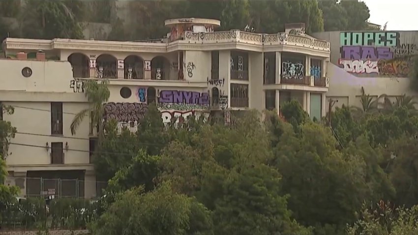 A Hollywood Hills mansion is covered in graffiti in September 2024.