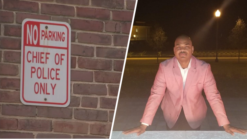 Sign reads, "No parking, Chief of police only" on brick wall and a photo of Rhaheem Blanden