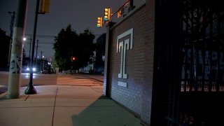 Temple University "T" logo on brick wall.