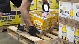 A worker stacks cases of Constellation Brands’ Corona beer for delivery at the Euclid Beverage LLC warehouse in Peru, Illinois.