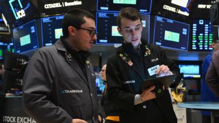 Traders work on the floor of the New York Stock Exchange (NYSE) during morning trading on January 11, 2024 in New York City.