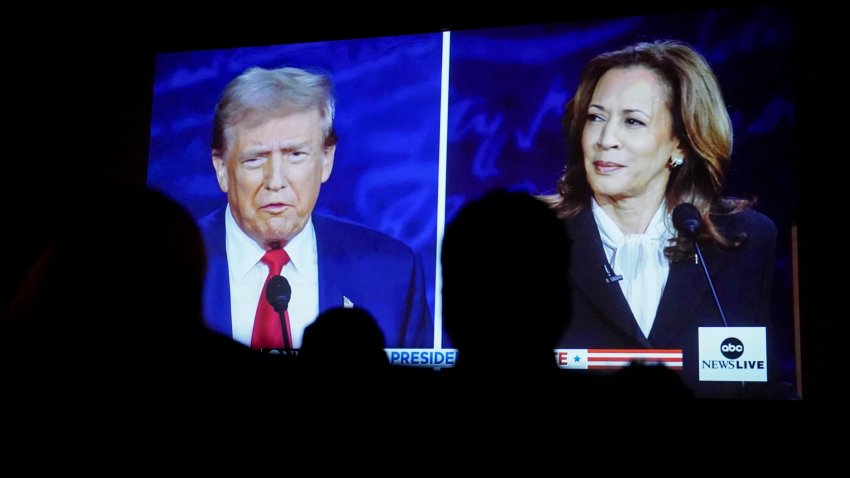 Former President Donald Trump and Vice President Kamala Harris are shown on screen during a debate watch party at the Cameo Art House Theatre in Fayetteville, North Carolina, Sept. 10, 2024.