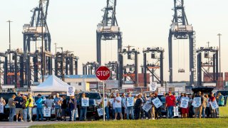 Longshoremen carry signs and chant Tuesday, Oct. 1, 2024, outside the Bayport Container Terminal in Seabrook.