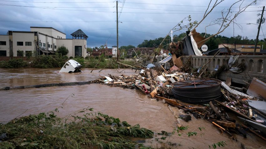 A van flows in floodwaters in the aftermath of Hurricane Helene on Sept. 28 in Asheville, North Carolina.