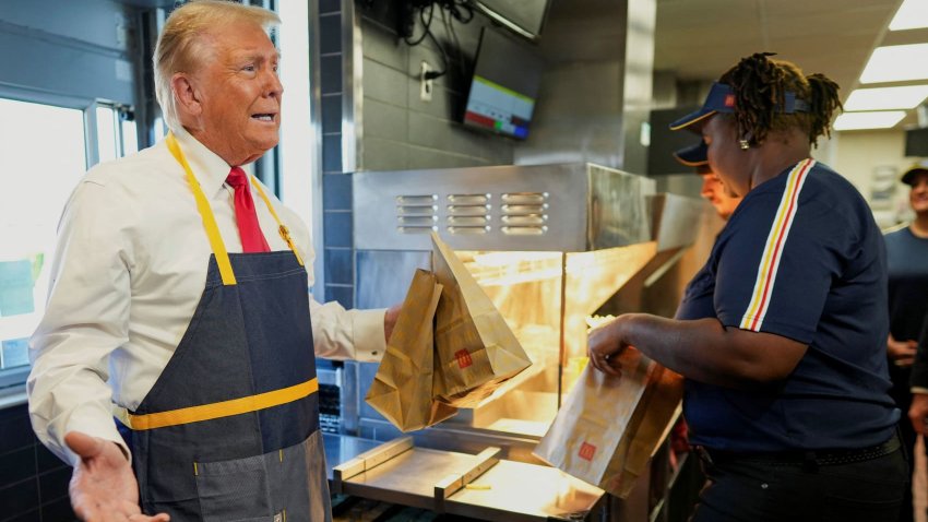 Republican presidential nominee and former U.S. President Donald Trump works behind the counter during a visit to McDonalds in Feasterville-Trevose, Pennsylvania, U.S. October 20, 2024. 