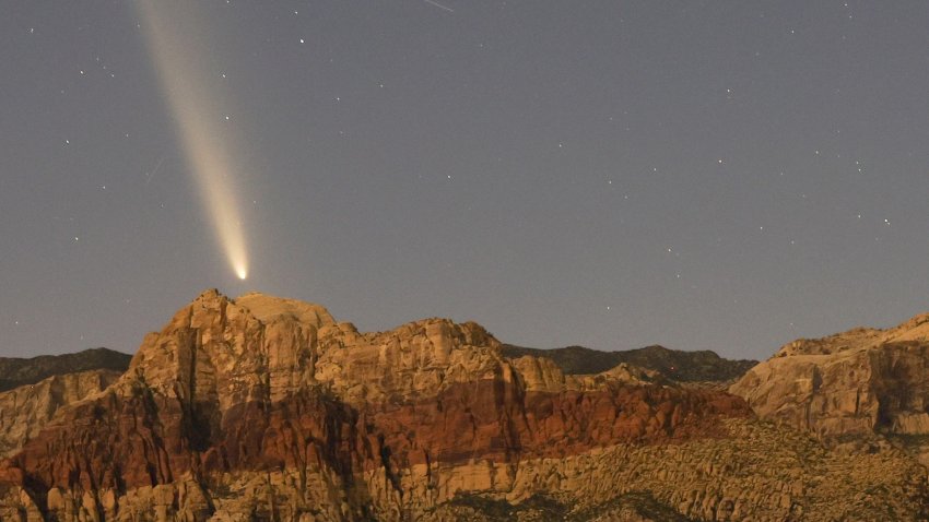 Comet appears over mountains