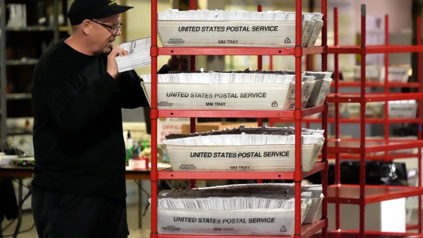 FILE – An Allegheny County worker processes mail-in and absentee ballots in Pittsburgh, April 18, 2024. (AP Photo/Gene J. Puskar, File)